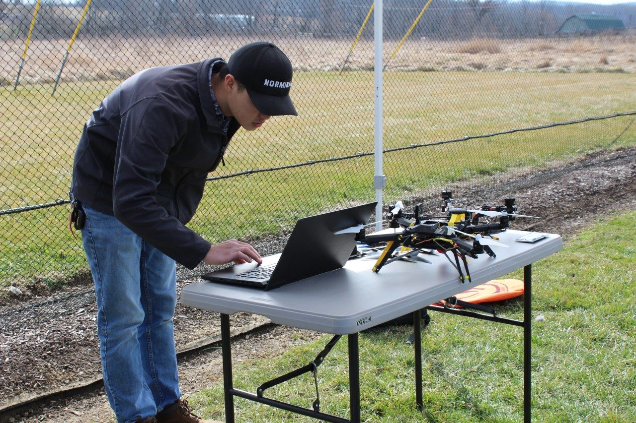 Student on laptop with drone